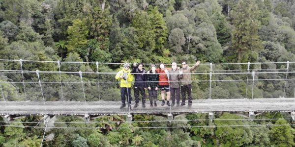 Drone shot of EBT team on spectacular swing bridge on timber trail
