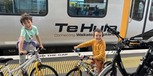 two kids excited to board the Te Huia train with their bikes from auckland to hamilton