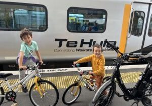 two kids excited to board the Te Huia train with their bikes from auckland to hamilton